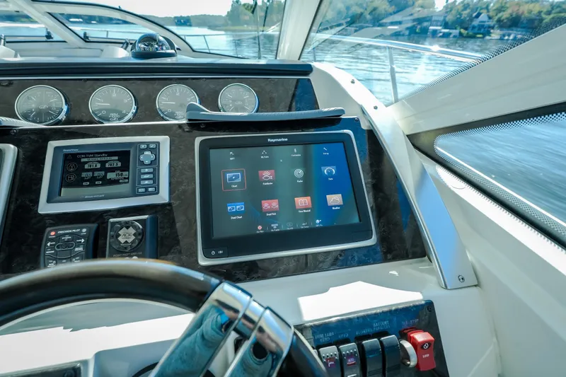 Slide: The Image of Dashboard of a 2012 Sea Ray 450 Sundancer yacht with navigation controls. - 27