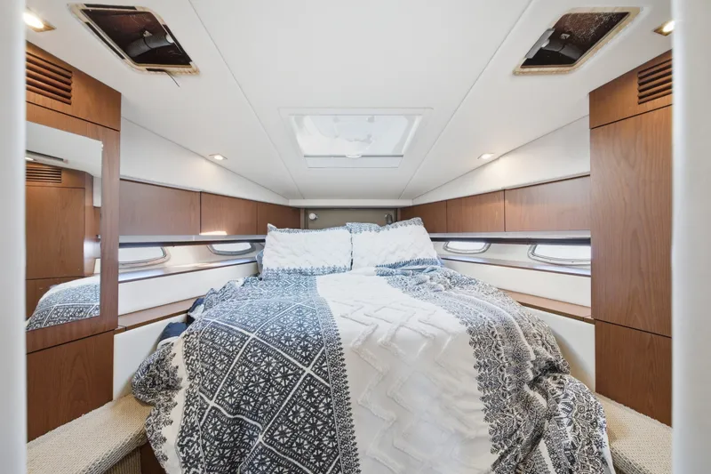 Slide: The Image of Luxurious cabin interior of 2012 Sea Ray 450 Sundancer yacht with cozy bedding. - 38