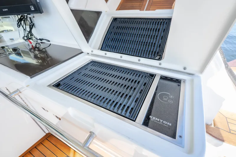 Slide: The Image of Outdoor grill on 2012 Sea Ray 450 Sundancer yacht, featuring Kenyon electric cooktop. - 57