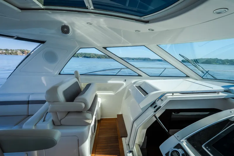 Slide: The Image of Interior view of 2012 Sea Ray 450 Sundancer yacht with luxurious seating and panoramic windows. - 32