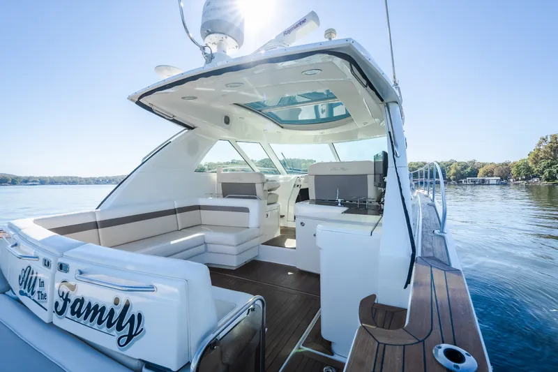 Slide: The Image of Luxurious 2012 Sea Ray 450 Sundancer yacht with spacious seating and scenic lake view. - 13