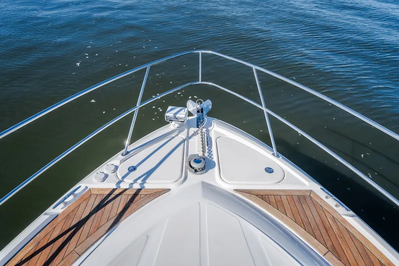 Slide: The Image of Bow view of 2012 Sea Ray 450 Sundancer yacht on calm water. - 48