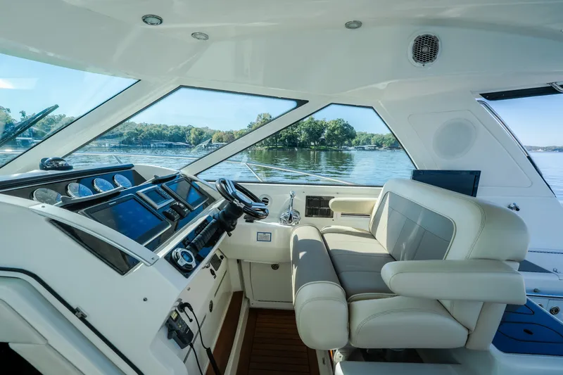 Slide: The Image of Interior view of 2012 Sea Ray 450 Sundancer yacht cockpit with luxurious seating and controls. - 23