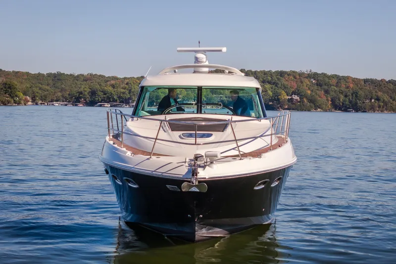 Slide: The Image of Front view of a 2012 Sea Ray 450 Sundancer yacht on a serene lake. - 2