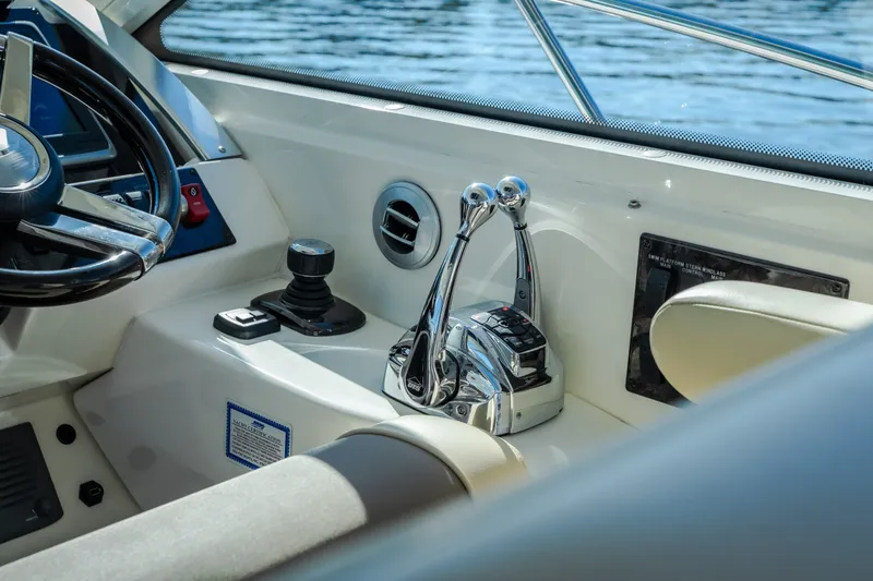 Slide: The Image of Control panel of a 2012 Sea Ray 450 Sundancer yacht with steering wheel and throttle levers. - 25