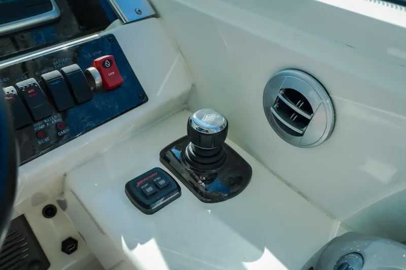 Slide: The Image of Control panel of a 2012 Sea Ray 450 Sundancer boat with joystick and switches. - 29