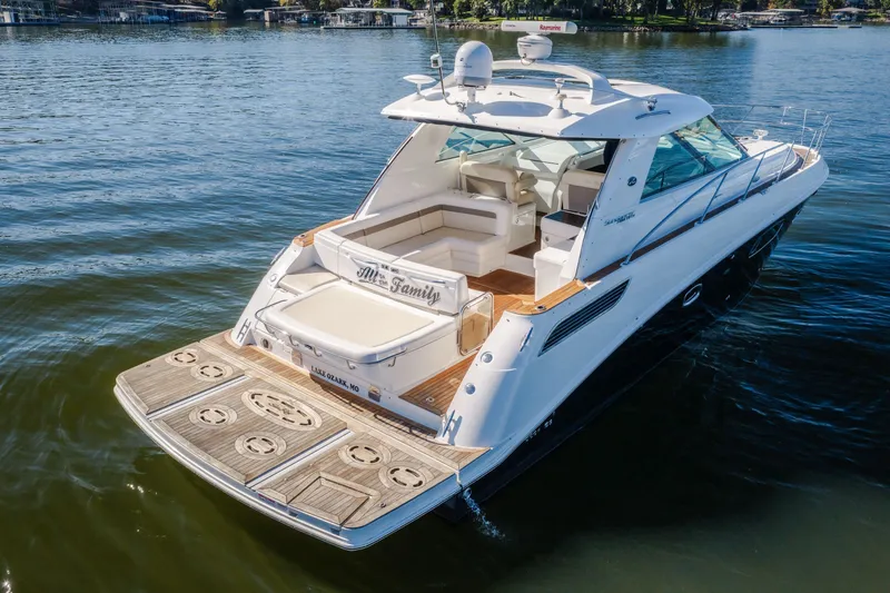 Slide: The Image of 2012 Sea Ray 450 Sundancer yacht on calm lake waters. - 9