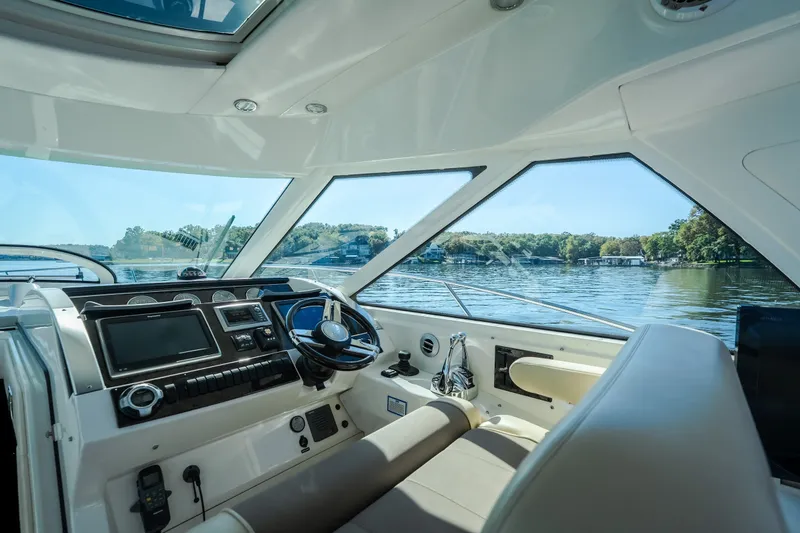 Slide: The Image of Interior view of 2012 Sea Ray 450 Sundancer yacht cockpit with scenic water backdrop. - 31