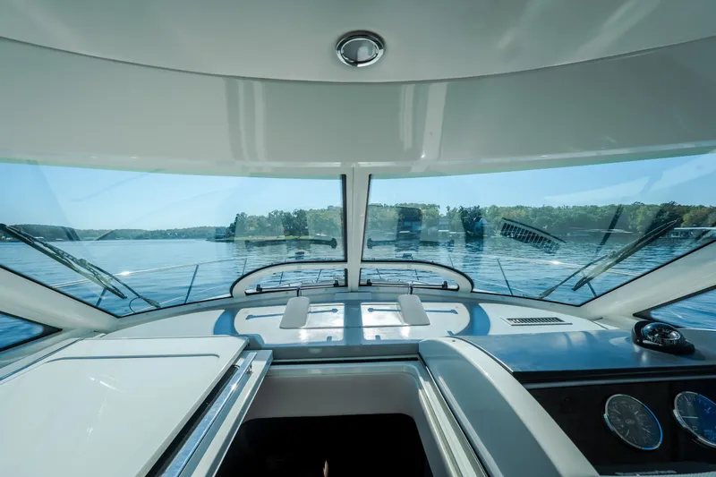 Slide: The Image of Interior view of 2012 Sea Ray 450 Sundancer yacht cockpit with lake scenery. - 30