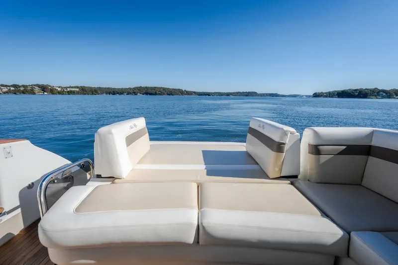 Slide: The Image of Luxury seating on a 2012 Sea Ray 450 Sundancer yacht overlooking serene blue waters. - 19