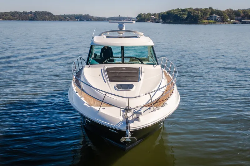 Slide: The Image of 2012 Sea Ray 450 Sundancer yacht on calm water, front view. - 51