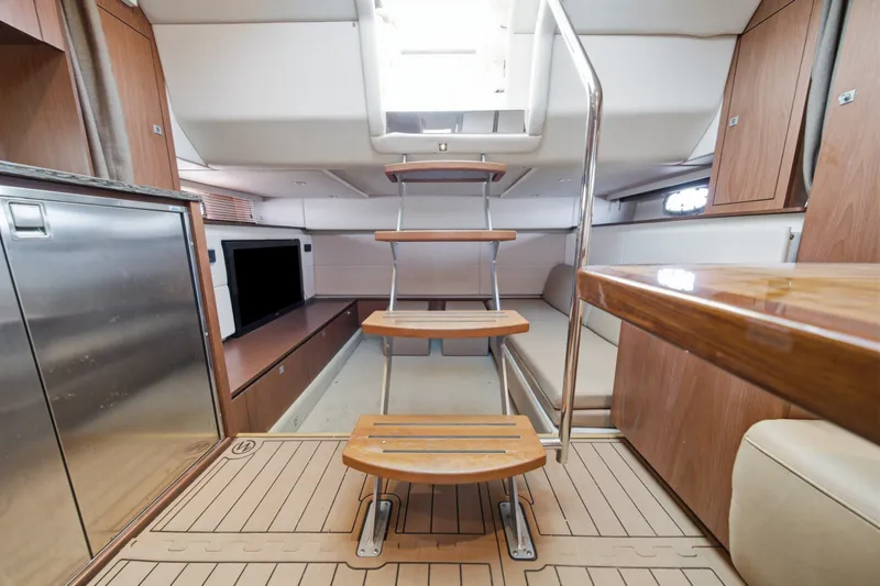 Slide: The Image of Interior of 2012 Sea Ray 450 Sundancer yacht with wooden stairs and modern furnishings. - 33
