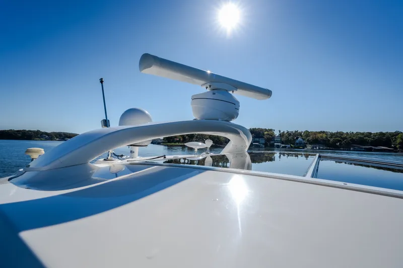 Slide: The Image of 2012 Sea Ray 450 Sundancer yacht under clear blue sky on calm water. - 58