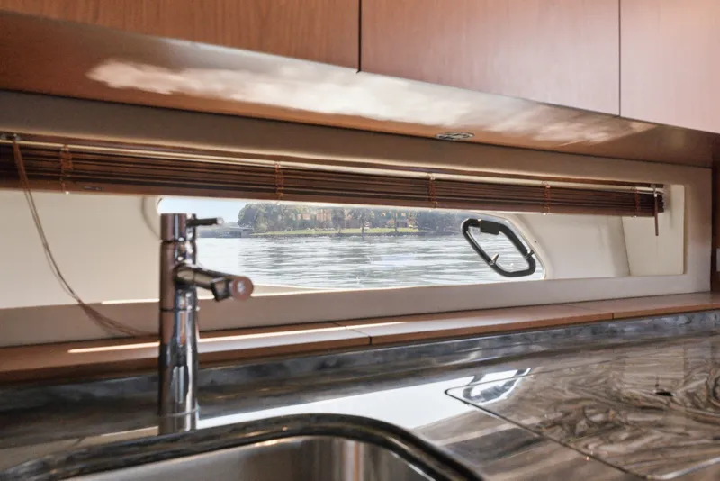 Slide: The Image of Interior view of 2012 Sea Ray 450 Sundancer yacht kitchen with window and sink. - 43