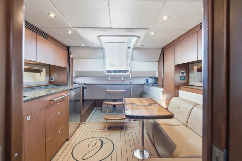 Slide: The Image of Luxurious interior of 2012 Sea Ray 450 Sundancer yacht with modern kitchen and seating area. - 45