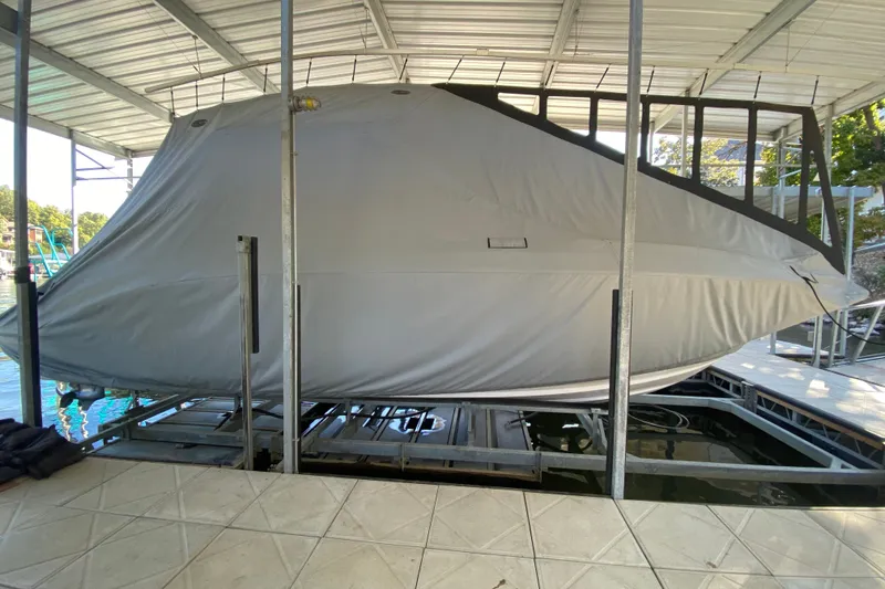 Slide: The Image of Covered 2012 Chaparral 327 SSX boat on a lift in a dock. - 36