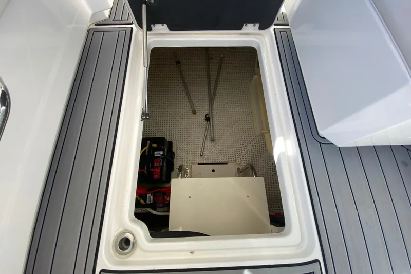 Slide: The Image of Open storage compartment on 2012 Chaparral 327 SSX boat deck. - 16