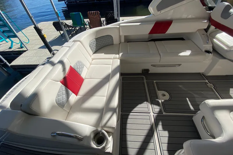Slide: The Image of Luxurious seating area on a 2012 Chaparral 327 SSX boat, docked by the water. - 22