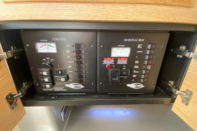 Slide: The Image of Electrical control panel on a 2012 Chaparral 327 SSX boat, featuring switches and meters. - 37