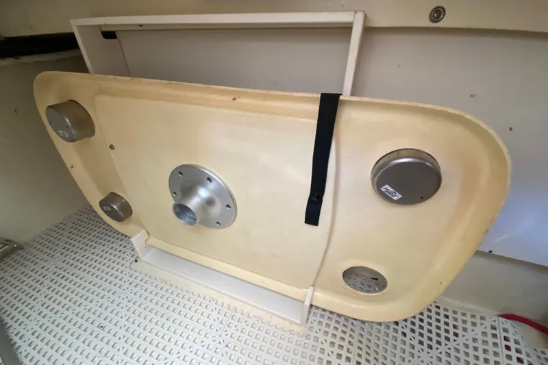 Slide: The Image of Storage compartment in a 2012 Chaparral 327 SSX boat, featuring a mounted table. - 29