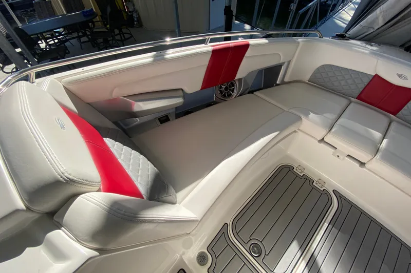 Slide: The Image of 2012 Chaparral 327 SSX boat interior with red and white seating and gray flooring. - 14