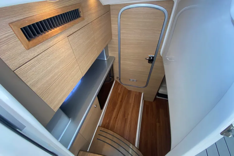 Slide: The Image of Interior of 2012 Chaparral 327 SSX boat with wood paneling and sleek design. - 38