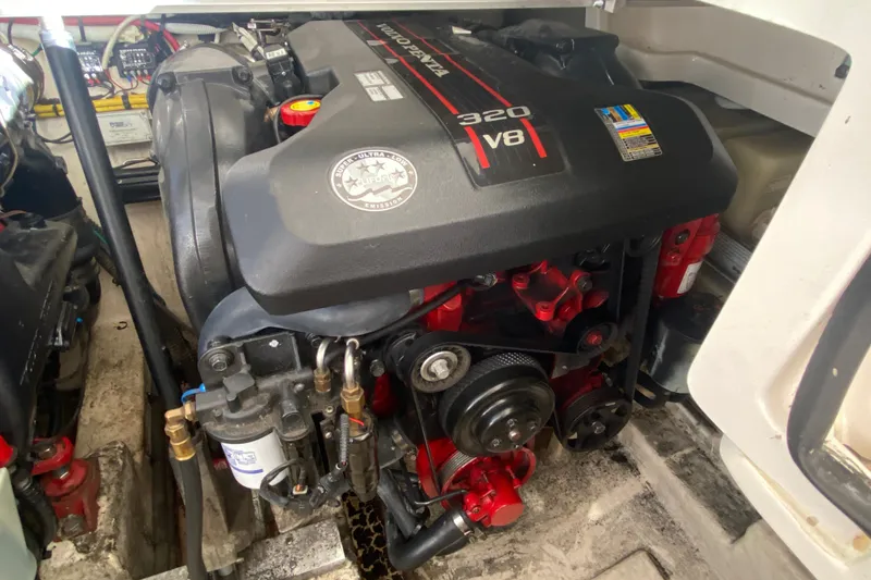 Slide: The Image of Engine compartment of a 2012 Chaparral 327 SSX boat, featuring a 320 V8 engine. - 33