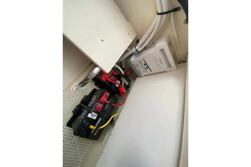 Slide: The Image of Battery compartment of 2012 Chaparral 327 SSX boat with wiring and charger. - 30
