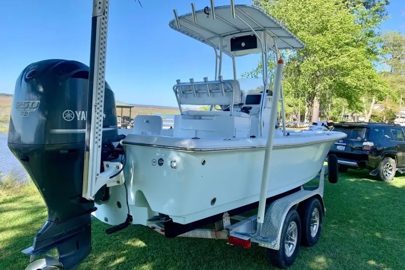 Slide: The Image of 2012 Sea Hunt BX22 Pro boat on trailer with Yamaha engine, parked on grass. - 9