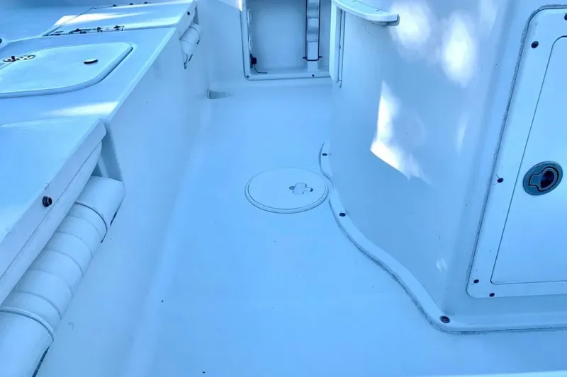 Slide: The Image of 2012 Sea Hunt BX22 Pro boat interior, featuring clean white deck and storage compartments. - 14