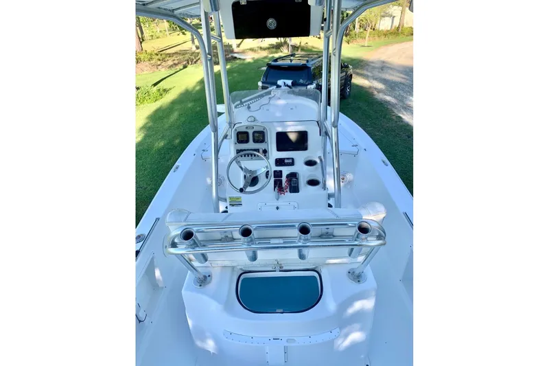 Slide: The Image of 2012 Sea Hunt BX22 Pro boat interior with steering console and rod holders. - 10