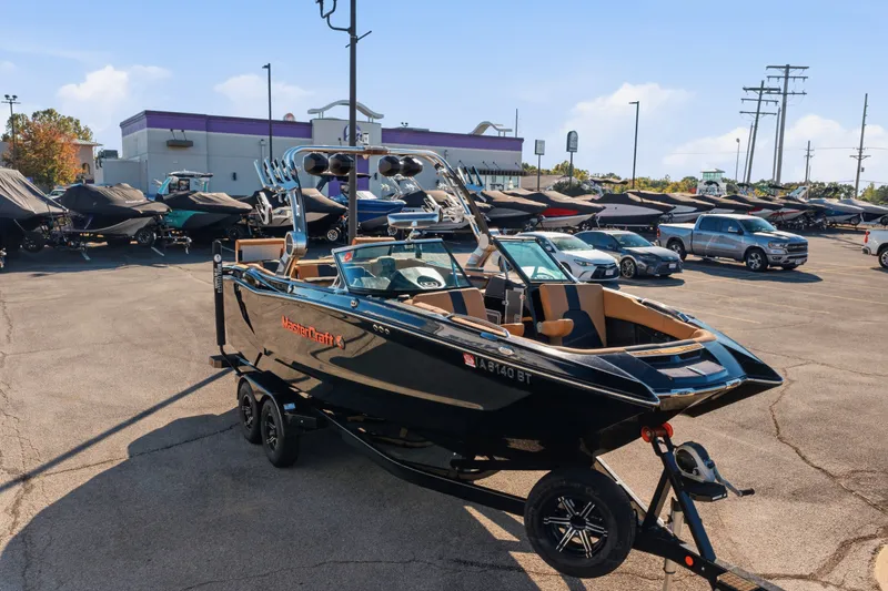 Slide: The Image of 2020 MasterCraft X24 boat on trailer in dealership parking lot. - 16