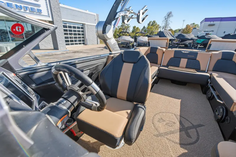 Slide: The Image of 2020 MasterCraft X24 boat interior with luxurious seating and modern steering wheel. - 36