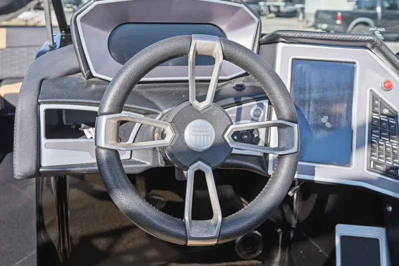 Slide: The Image of Steering wheel and dashboard of 2020 MasterCraft X24 boat, featuring modern controls and touchscreen. - 27