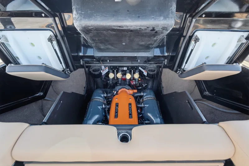 Slide: The Image of 2020 MasterCraft X24 engine compartment with Ilmor engine, showcasing open storage hatches. - 42