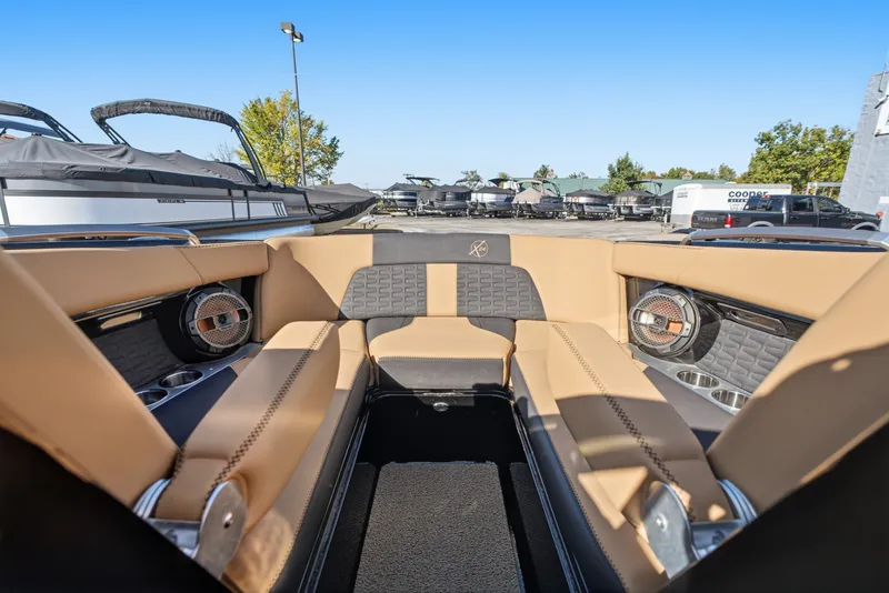 Slide: The Image of Interior of a 2020 MasterCraft X24 boat with tan seating and speakers. - 32
