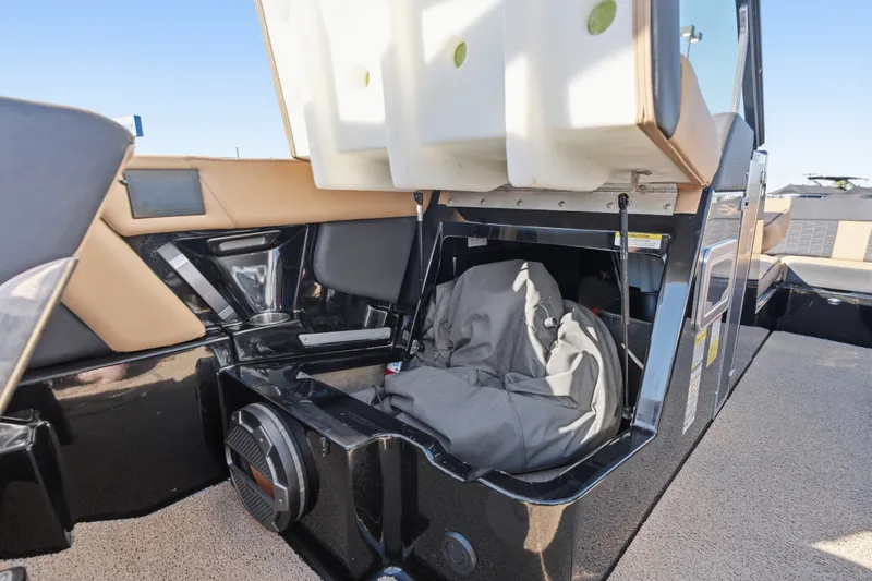 Slide: The Image of 2020 MasterCraft X24 boat interior storage compartment with open seat and speaker. - 39