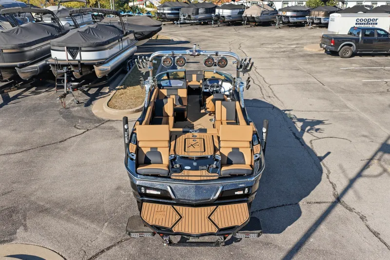 Slide: The Image of 2020 MasterCraft X24 boat with tan seating, parked in a marina lot. - 47