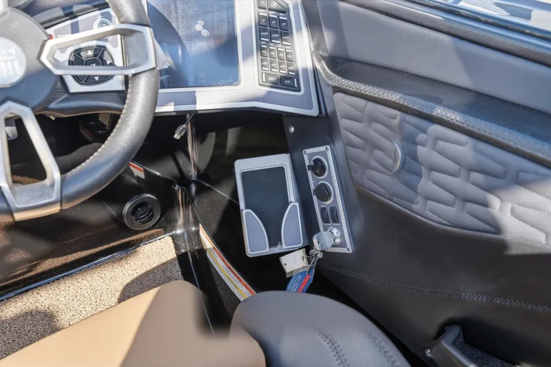 Slide: The Image of Interior dashboard of 2020 MasterCraft X24 boat with steering wheel and control panel. - 28