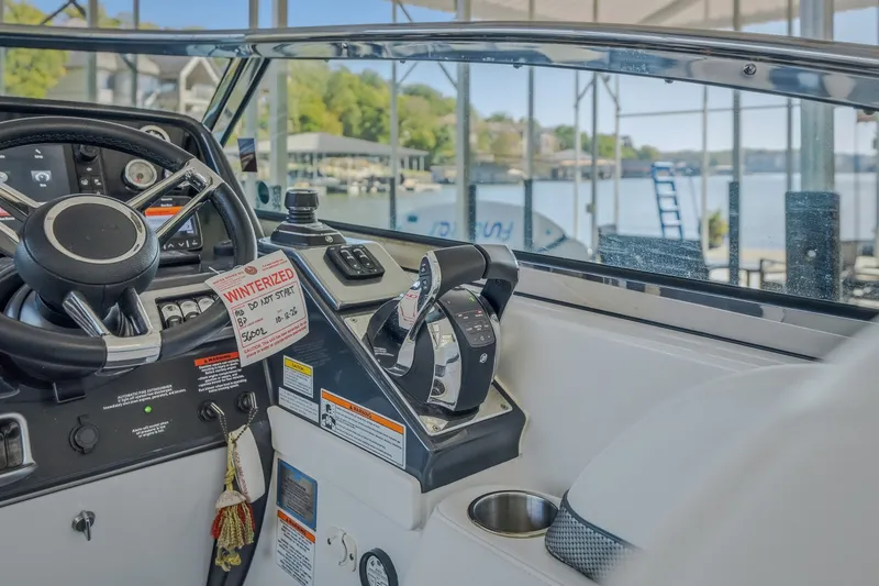 Slide: The Image of 2017 Formula 37 Performance Cruiser helm with controls, steering wheel, and lake view. - 26