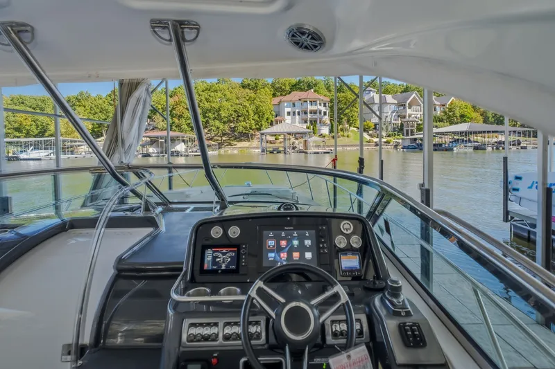Slide: The Image of Cockpit view of 2017 Formula 37 Performance Cruiser overlooking a serene marina. - 27