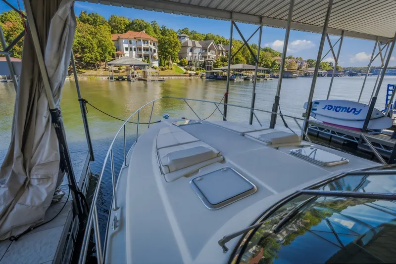 Slide: The Image of 2017 Formula 37 Performance Cruiser docked, overlooking serene waterfront homes and lush greenery. - 43