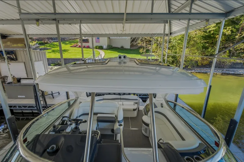 Slide: The Image of 2017 Formula 37 Performance Cruiser docked under a covered marina with scenic background. - 46