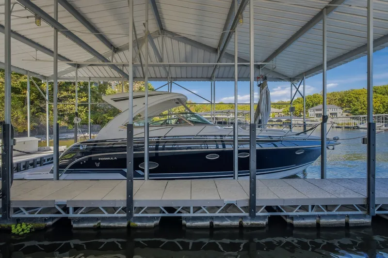 Slide: The Image of 2017 Formula 37 Performance Cruiser docked under a covered marina. - 67