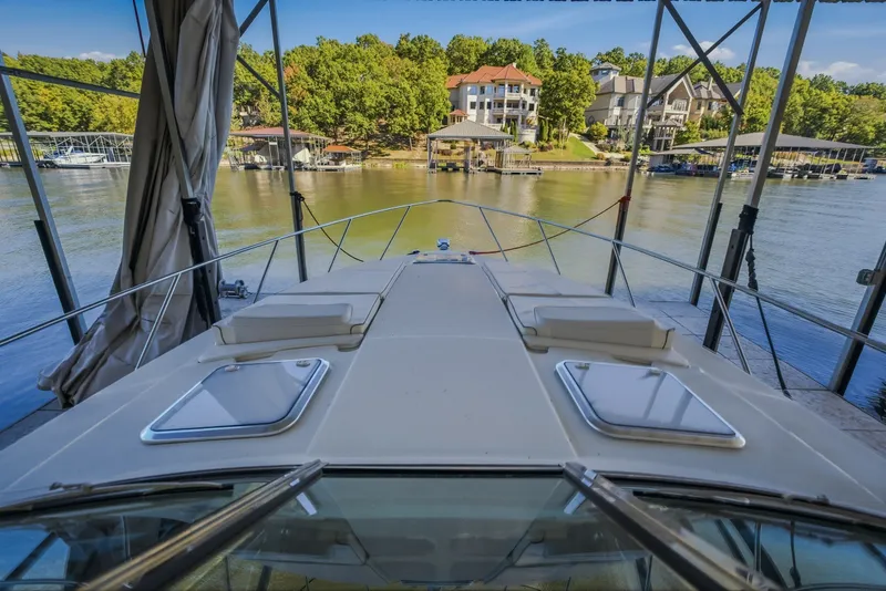 Slide: The Image of 2017 Formula 37 Performance Cruiser docked, overlooking serene waterfront homes and lush greenery. - 37