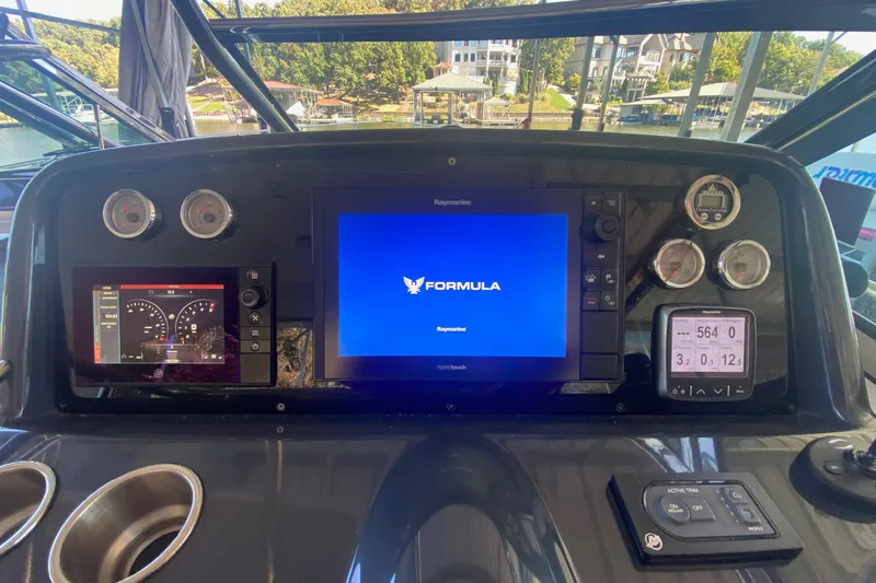 Slide: The Image of Cockpit dashboard of a 2017 Formula 37 Performance Cruiser with navigation displays. - 69
