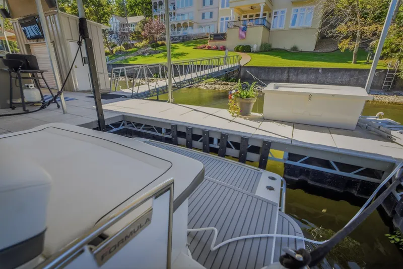 Slide: The Image of 2017 Formula 37 Performance Cruiser docked at a scenic lakeside property. - 65