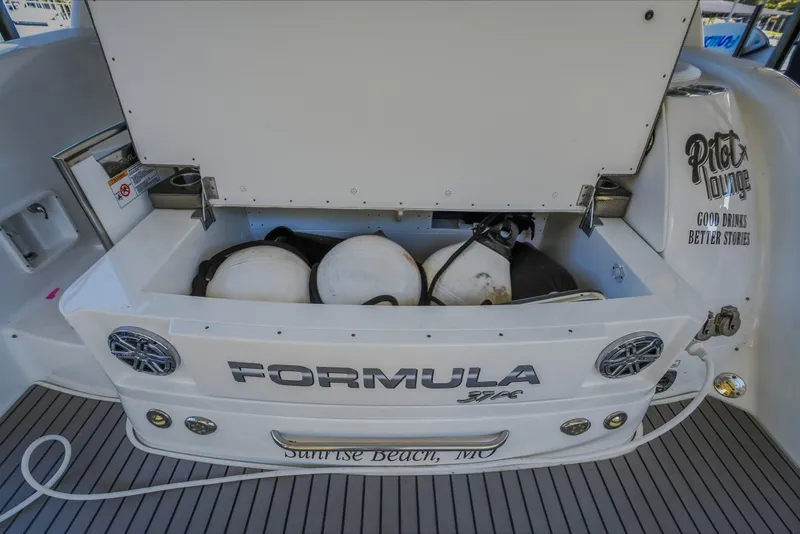 Slide: The Image of 2017 Formula 37 Performance Cruiser with storage compartment open, showcasing fenders and equipment. - 18