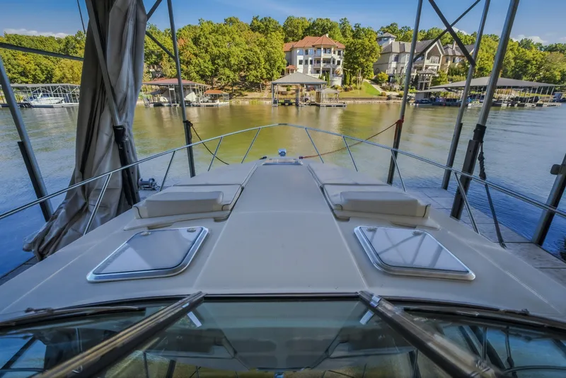 Slide: The Image of 2017 Formula 37 Performance Cruiser docked, overlooking serene waterfront homes and lush greenery. - 38
