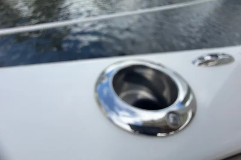 Slide: The Image of Close-up of a 2019 Sailfish 245 DC boat's stainless steel cup holder. - 46